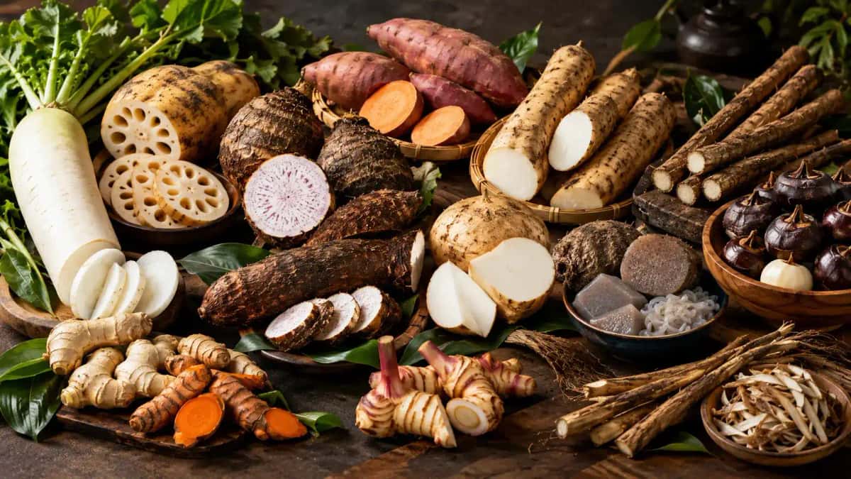 Asiatiska rotfrukter som daikon, lotusrot, taro och ingefära på ett bord